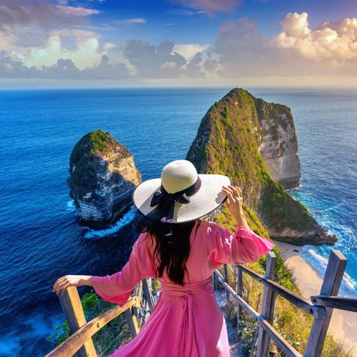 Woman walking at Kelingking Beach in Nusa penida island, Bali, Indonesia. Woman walking at Kelingking Beach in Nusa penida island, Bali, Indonesia.
